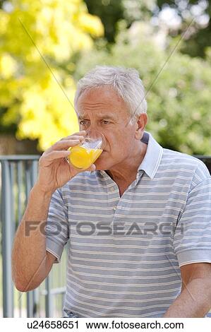 Stock Image - Diabetic man drinking a glucose drink.. Fotosearch