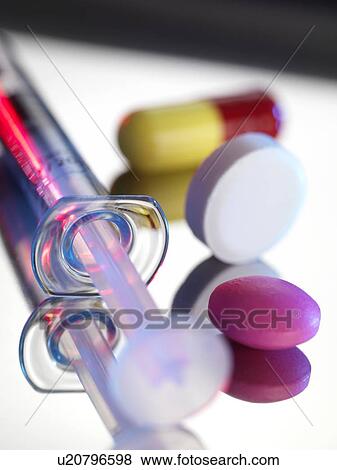 Drugs. Tablets and a syringe View Large Photo Image Stock Photo - Drugs. Tablets and a syringe. Fotosearch