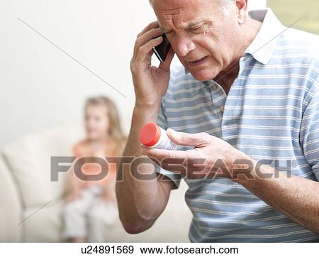 First aid for poisoning. Man giving ambulance control information on a substance swallowed by a young girl. View Large Photo Image Stock Photo - First aid for poisoning. Man giving ambulance control information on a substance swallowed by a young girl.. Fotosearch