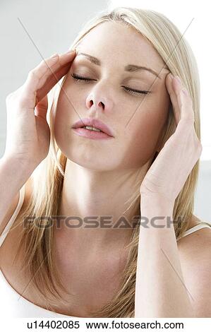 Headache. Woman rubbing her temples. View Large Photo Image Stock Photography - Headache. Woman rubbing her temples.. Fotosearch