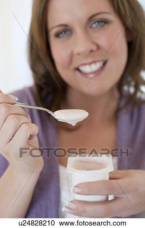 Healthy eating. Woman eating a yoghurt. View Large Photo Image Stock Image - Healthy eating. Woman eating a yoghurt.. Fotosearch