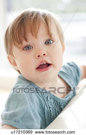 Stock Photo - Inquisitive toddler. She is 15 months old.. Fotosearch