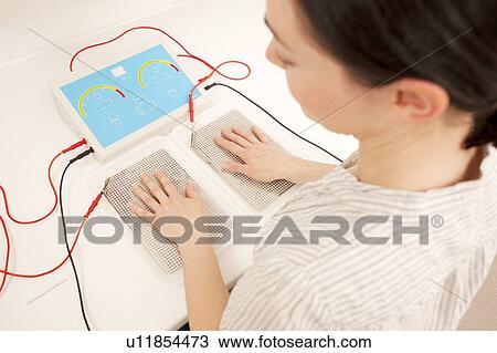 Iontophoresis. This is a treatment for excess sweating of the hands. View Large Photo Image Stock Image - Iontophoresis. This is a treatment for excess sweating of the hands.. Fotosearch