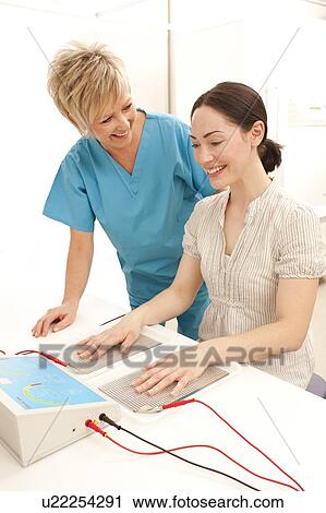 Stock Image - Iontophoresis. This is a treatment for excess sweating of the hands.. Fotosearch