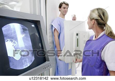 Man having a barium X-ray examination. View Large Photo Image Stock Image - Man having a barium X-ray examination.. Fotosearch