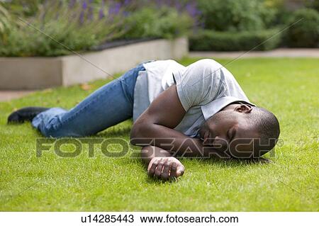 Stock Image - Man in recovery position.. Fotosearch