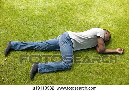 Stock Image - Man in recovery position.. Fotosearch