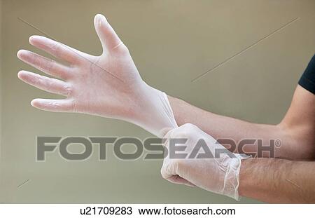 Man putting on latex gloves. View Large Photo Image Stock Image - Man putting on latex gloves.. Fotosearch