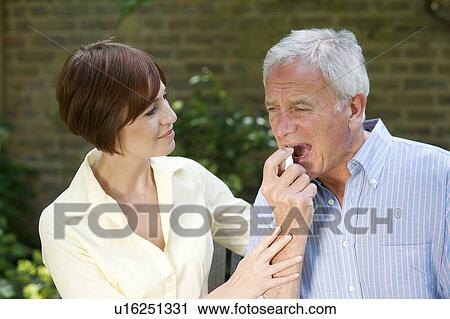 Man using angina spray. View Large Photo Image Stock Image - Man using angina spray.. Fotosearch