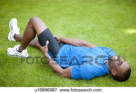 Man with cramp in his thigh. View Large Photo Image Stock Photo - Man with cramp in his thigh.. Fotosearch