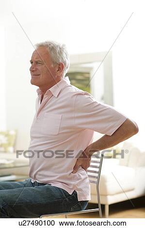 Stock Image - Man with lower back pain.. Fotosearch