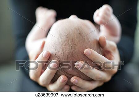 Stock Photo - Mother and baby. Mother holding her 2 month old baby.. Fotosearch