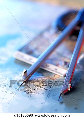 Stock Photograph - Navigation. Dividers and compass sitting on a map.. Fotosearch