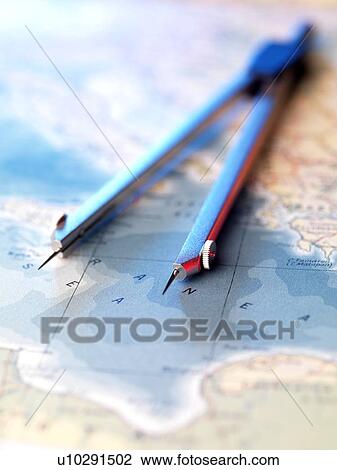 Stock Image - Navigation. Dividers sitting on a map.. Fotosearch