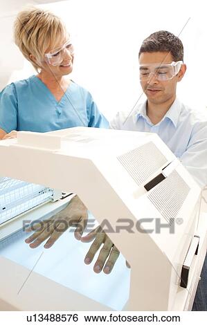 Phototherapy booth. Patient with their hands in a phototherapy box. View Large Photo Image Stock Photograph - Phototherapy booth. Patient with their hands in a phototherapy box.. Fotosearch