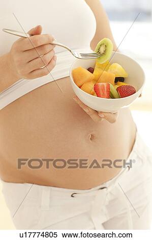 Pregnant woman eating a fruit salad. View Large Photo Image Stock Photography - Pregnant woman eating a fruit salad.. Fotosearch
