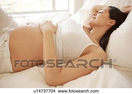 Pregnant woman sleeping. View Large Photo Image Picture - Pregnant woman sleeping.. Fotosearch