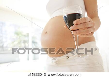 Pregnant woman with a glass of wine. View Large Photo Image Stock Image - Pregnant woman with a glass of wine.. Fotosearch