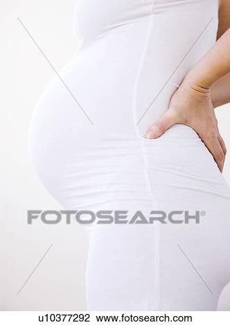 Pregnant woman's abdomen. She is eight and a half months pregnant. View Large Photo Image Stock Image - Pregnant woman's abdomen. She is eight and a half months pregnant.. Fotosearch