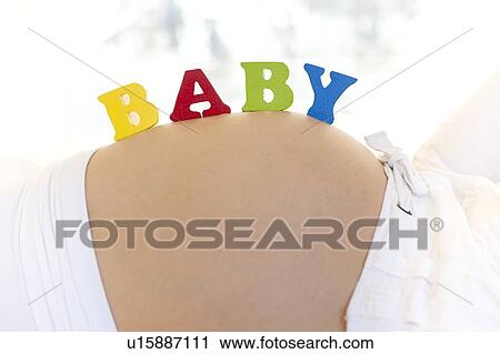 Stock Image - Pregnant woman's abdomen.. Fotosearch