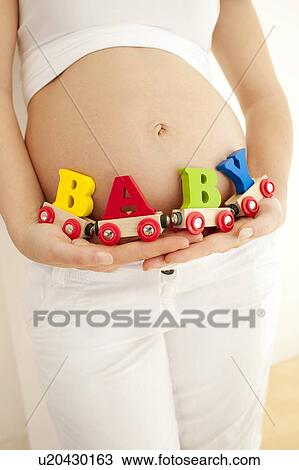 Stock Image - Pregnant woman's abdomen.. Fotosearch