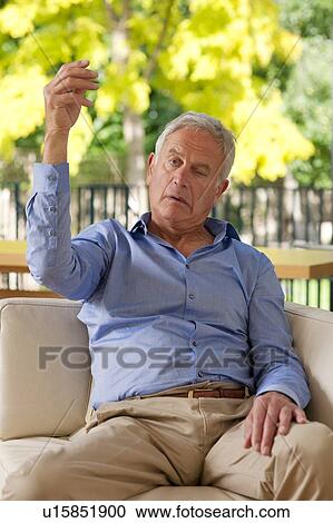 Senior man having a stroke. He is only able to raise one arm, not both, because of the stroke. View Large Photo Image Stock Image - Senior man having a stroke. He is only able to raise one arm, not both, because of the stroke.. Fotosearch