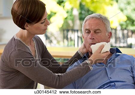 Senior man having a stroke. He is experiencing facial weakness. View Large Photo Image Stock Image - Senior man having a stroke. He is experiencing facial weakness.. Fotosearch