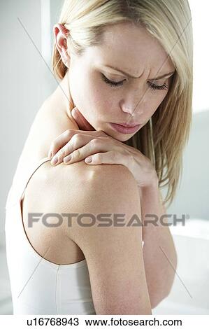 Shoulder pain. Woman rubbing her shoulder. View Large Photo Image Stock Image - Shoulder pain. Woman rubbing her shoulder.. Fotosearch