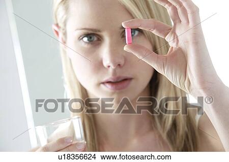 Taking a pill. View Large Photo Image Picture - Taking a pill.. Fotosearch