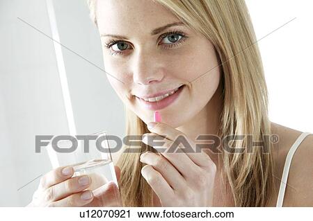 Taking a pill. View Large Photo Image Stock Image - Taking a pill.. Fotosearch