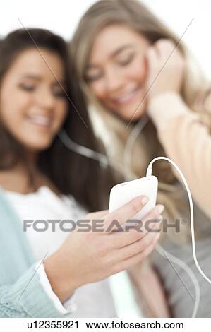 Teenage friends listening to music. View Large Photo Image Stock Image - Teenage friends listening to music.. Fotosearch