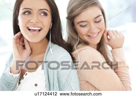 Stock Image - Teenage friends listening to music.. Fotosearch