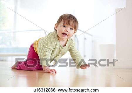 Stock Photograph - Toddler crawling. She is 15 months old.. Fotosearch