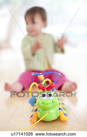 Toddler playing. She is 15 months old. View Large Photo Image Stock Photograph - Toddler playing. She is 15 months old.. Fotosearch