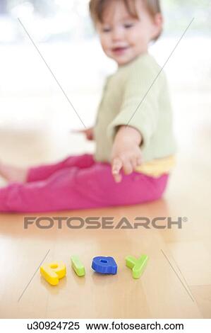 Toddler playing. She is 15 months old. View Large Photo Image Stock Photography - Toddler playing. She is 15 months old.. Fotosearch
