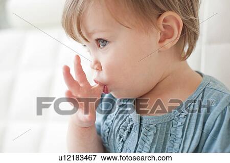 Toddler sucking her thumb. She is 15 months old. View Large Photo Image Stock Photo - Toddler sucking her thumb. She is 15 months old.. Fotosearch