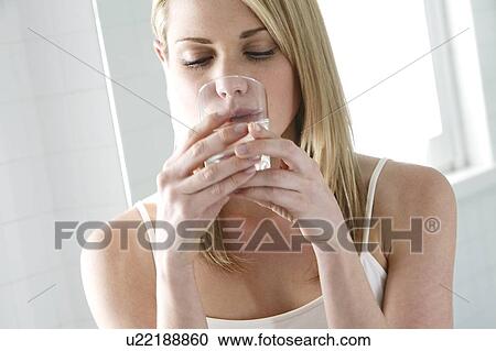 Woman drinking a glass of water. View Large Photo Image Stock Image - Woman drinking a glass of water.. Fotosearch