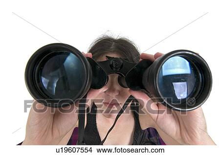 Woman looks through a binoculars facing camera wide angle view View Large Photo Image Picture - Woman looks through a binoculars facing camera wide angle view. Fotosearch