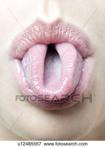 Stock Photo - Woman rolling her tongue.. Fotosearch