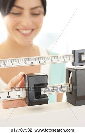 Woman weighing herself. View Large Photo Image Stock Image - Woman weighing herself.. Fotosearch