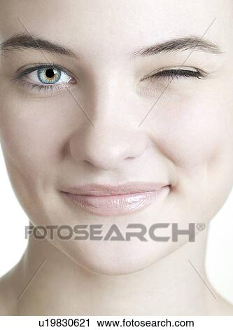 Stock Image - Woman winking.. Fotosearch