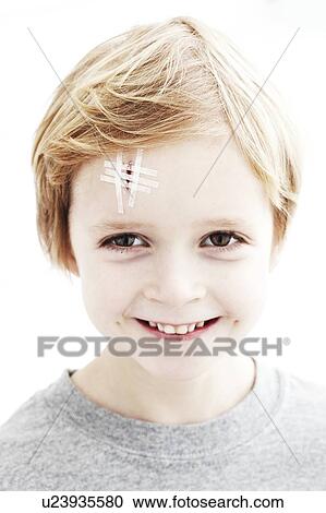 Young boy with head wound. The wound is closed with steri-strips. View Large Photo Image Stock Image - Young boy with head wound. The wound is closed with steri-strips.. Fotosearch