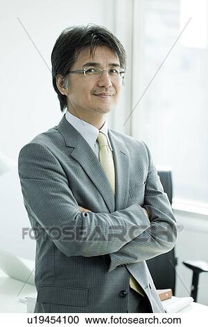 A businessman holding arms View Large Photo Image Stock Image - A businessman holding arms. Fotosearch