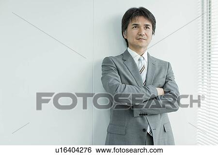 A businessman holding arms View Large Photo Image Stock Photograph - A businessman holding arms. Fotosearch