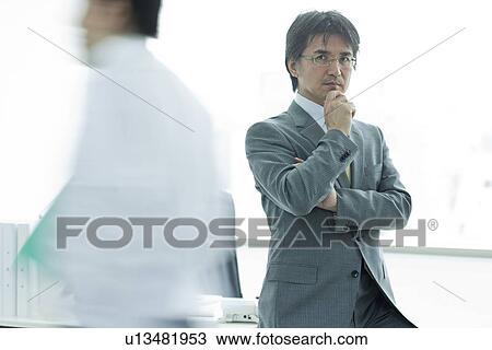 Stock Image - A businessman in the office. Fotosearch