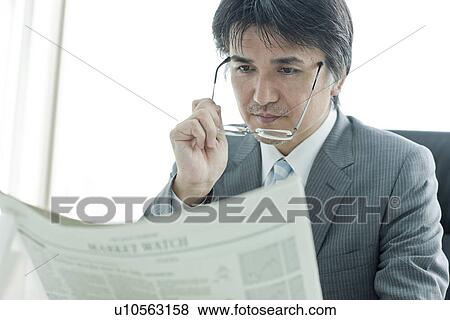A businessman reading newspapers View Large Photo Image Stock Photo - A businessman reading newspapers. Fotosearch