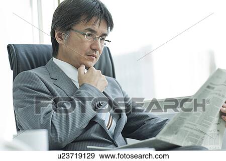 A businessman reading newspapers View Large Photo Image Stock Photo - A businessman reading newspapers. Fotosearch