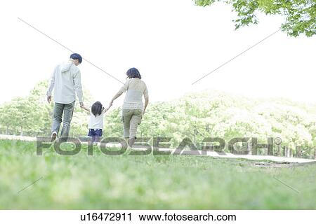 Stock Image - A family holding hands. Fotosearch