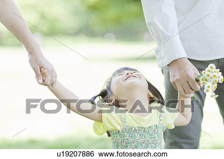 Stock Photograph - A family holding hands. Fotosearch