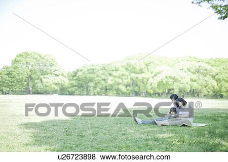 A family sitting at the park View Large Photo Image Stock Photo - A family sitting at the park. Fotosearch